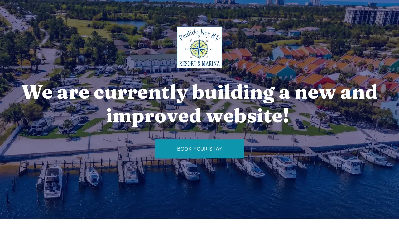 Perdido Key RV Resort and Marina homepage — an aerial photo of boats, docks and RV sites with a booking button